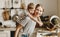 Preparation of family breakfast. mother and child son cut bread  and eat cookies with milk in morning