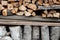 Preparation of firewood for the winter. Stacks of firewood. Pile of firewood