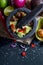 Preparation of guacamole in a traditional stone mortar with all its ingredients chopped avocados, lime, onion, tomatoes and chili