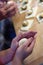 Preparation of homemade fruit dumplings with plums. Czech specialty of sweet good food. Dough on kitchen wooden table with hands
