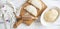 Preparation of homemade pies with cheese and fresh herbs filling. On a wooden board, dough and rolling pin, a towel with a pattern