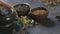 Preparation of medicinal herbs for use. Medicinal plants on the table. Woman rubs medicinal plants in a mortar