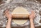 Preparation of pastry. Woman rolling dough, top view