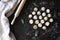 Preparation of pelmeni. Top view. Ingredients on black table. Traditional Russian cuisine.