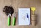 Preparation for planting seeds at home. A notebook with a record of the landing plan. Garden objects on the table top view