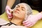 Preparation for procedures in the cosmetologist s office. Beautician in gloves, putting on a hat