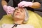 Preparation for procedures in the cosmetologist s office. Beautician in gloves, putting on a hat