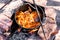 Preparation of raditional armenian pilaf in a cauldron on an open fire