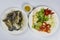 Preparation with raw crab, lemon, onion, pepper, tomato, herbs and spices on white plate, top view, Sea food.