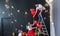 Preparation for St. Valentine`s Day. The young family hangs up festive red heart balloons