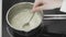 Preparation and Stirring Oatmeal in pan on the kitchen stove