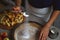 Preparation, Thanksgiving Celebration: The cook sprinkles white sugar from a silver spoon on the apple pie dough