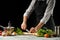 Preparation of tomato sauce by the hands of the chef, steps the process in the kitchen on a black background copy the text of the