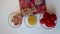 Preparation of tomato soup. A man cuts chicken pieces. Next to the table are other ingredients vermicelli and tomatoes.