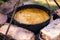 Preparation of traditional Armenian pilaf in a cauldron on an open fire