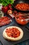 Preparation traditional mexican enchiladas with chicken meat, spicy tomato sauce and cheese