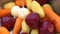 Preparation Ukrainian borscht, peeled carrots, beets, and potatoes are seen being washed in a sink.