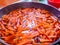 Preparation of Uzbek pilaf - roasting meat and carrots in oil, zirvak, close up