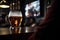 Preparation for watching the sport game.Cooled glass of beer with condensate on the wooden table.