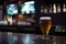 Preparation for watching the sport game.Cooled glass of beer with condensate on the wooden table.