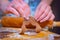 Preparations for Christmas, the hands of a woman hold a piece of cake for gingerbread cookie stars almost ready to bake