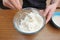 Prepare the dough for homemade pizza, hand knead the dough with yeast