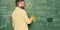 Prepare for lesson. Teacher bearded man cleaning chalkboard background. Teacher wiping chalkboard. School principal