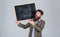 Prepare for new school year. Teacher bearded man stands and holds blackboard inscription back to school grey background