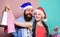 Prepare presents in advance. Merry christmas. Man and woman shopping. Christmas shopping. Cheerful couple Santa hats
