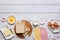 Prepared ingredients for making a hot croque madame sandwich on a white wooden background. Recipes for sandwiches, hot breakfasts