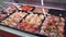 prepared meat for home cooking in supermarket, chicken, pork and beef in display case, panoramic