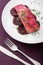 Prepared salmon fillet with beet and sauce on white plate