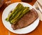 Prepared steak of beef with asparagus at plate