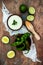 Preparing avocado cilantro sauce for fish tacos. Lime crema in a bowl on vintage stone background.