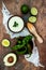 Preparing avocado cilantro sauce for fish tacos. Lime crema in a bowl on vintage stone background.