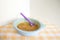 Preparing baby food, homemade.Top view of a bowl with mixed boiled apples in a blue bowl on a tablecloth. Healthy food kids