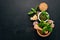 Preparing basil pesto sauce. Basil, parmesan cheese, olive oil. Top view. On a black wooden background.