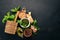 Preparing basil pesto sauce. Basil, parmesan cheese, olive oil. Top view. On a black wooden background.