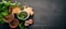 Preparing basil pesto sauce. Basil, parmesan cheese, olive oil. Top view. On a black wooden background.