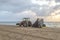 Preparing the beach early morning with a tractor and a roller