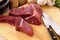 Preparing beef steak for casserole or stew with ingredients and knife on wood cutting board