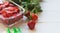 Preparing berries for freezing. Red ripe freshly picked strawberries and packages for freezing on a white table