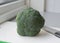 Preparing broccoli cut on white cutting board with knife