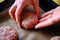 Preparing burger patties, raw burger meat