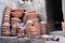 Preparing clay pottery for firing in adobe furnace, Fez, Morocco