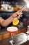 Preparing Cocktails. Bartender Making Cocktail In Bar