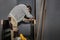 Preparing the door for installation. A man installs a door handle