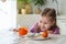 Preparing for Easter. A cute little girl sits at a table and paints eggs