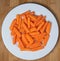 Preparing fresh carrots on wood table