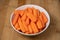 Preparing fresh carrots on wood table